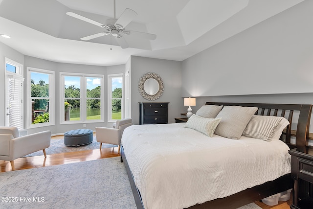 188 Edgewater Cir, Sunset Beach, NC 28468 - bedroom with multiple windows, wood finished floors, recessed lighting, and ceiling fan