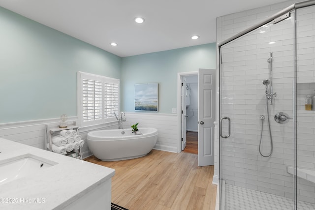 188 Edgewater Cir, Sunset Beach, NC 28468 - bathroom featuring a freestanding bath, a stall shower, vanity, a wainscoted wall, and recessed lighting