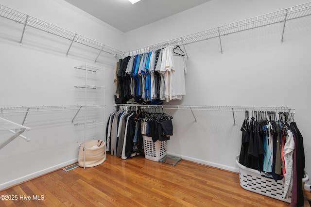 188 Edgewater Cir, Sunset Beach, NC 28468 - walk in closet featuring wood finished floors