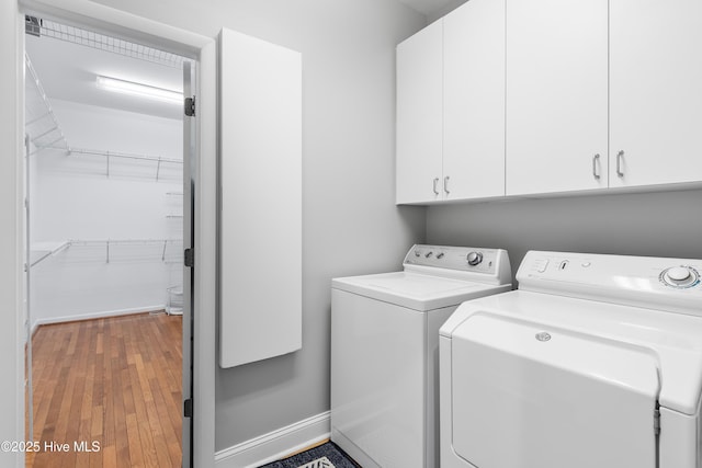 188 Edgewater Cir, Sunset Beach, NC 28468 - laundry room with washing machine and clothes dryer, cabinet space, and wood finished floors
