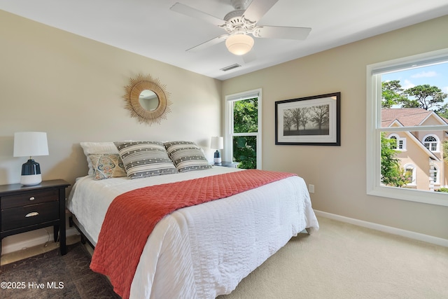 188 Edgewater Cir, Sunset Beach, NC 28468 - carpeted bedroom with multiple windows and ceiling fan