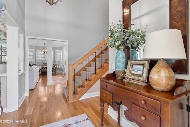 188 Edgewater Cir, Sunset Beach, NC 28468 - stairway with a towering ceiling, wood finished floors, and a chandelier