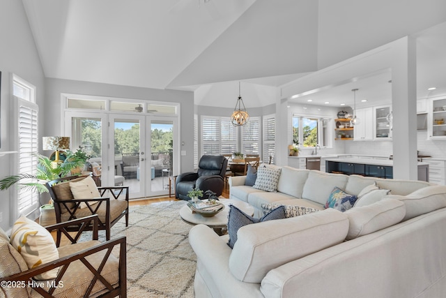 188 Edgewater Cir, Sunset Beach, NC 28468 - living area featuring french doors, high vaulted ceiling, light wood-type flooring, recessed lighting, and a chandelier