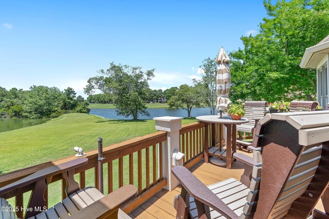 188 Edgewater Cir, Sunset Beach, NC 28468 - wooden terrace featuring a water view, a lawn, and view of wooded area