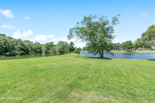 188 Edgewater Cir, Sunset Beach, NC 28468 - view of green lawn with a water view