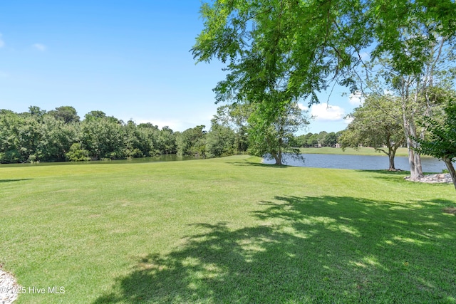 188 Edgewater Cir, Sunset Beach, NC 28468 - view of green lawn with a water view