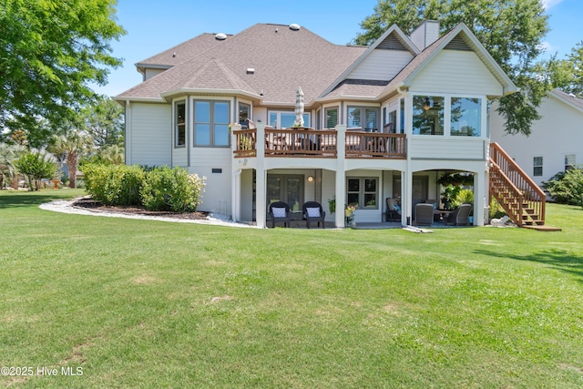 188 Edgewater Cir, Sunset Beach, NC 28468 - rear view of house with a deck, roof with shingles, a yard, a chimney, and stairway