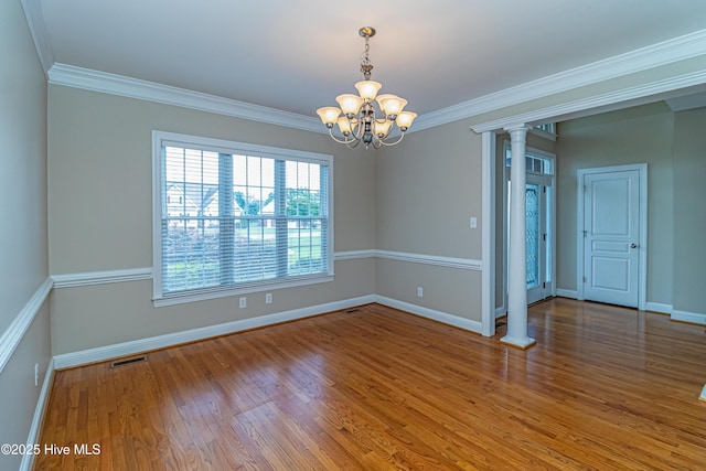 112 Highwoods Dr, Goldsboro, NC 27530 - empty room with a chandelier, crown molding, wood finished floors, and decorative columns