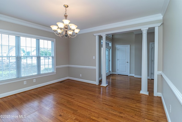 112 Highwoods Dr, Goldsboro, NC 27530 - spare room featuring a chandelier, wood finished floors, crown molding, and ornate columns