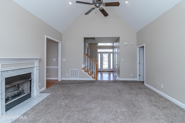 112 Highwoods Dr, Goldsboro, NC 27530 - unfurnished living room featuring carpet flooring, high vaulted ceiling, a ceiling fan, stairway, and a fireplace