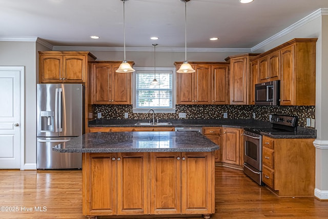 112 Highwoods Dr, Goldsboro, NC 27530 - kitchen featuring stainless steel appliances, wood finished floors, a kitchen island, brown cabinetry, and recessed lighting