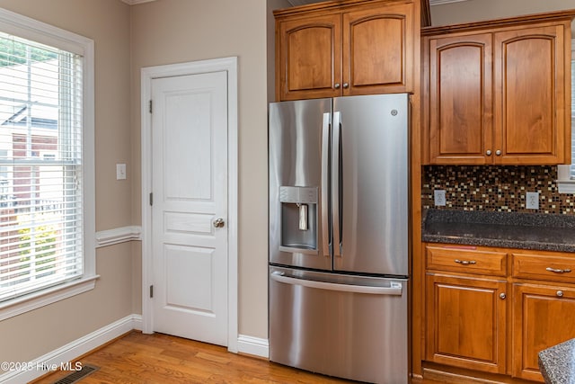112 Highwoods Dr, Goldsboro, NC 27530 - kitchen featuring stainless steel refrigerator with ice dispenser, light wood-style flooring, and brown cabinetry