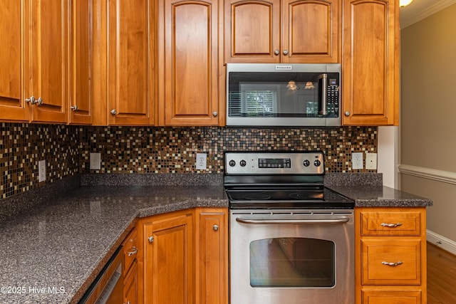 112 Highwoods Dr, Goldsboro, NC 27530 - kitchen featuring appliances with stainless steel finishes, tasteful backsplash, ornamental molding, brown cabinetry, and dark stone counters