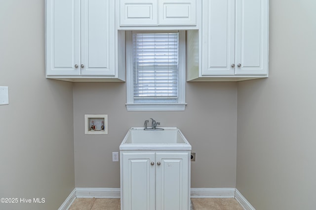 112 Highwoods Dr, Goldsboro, NC 27530 - washroom with washer hookup, light tile patterned flooring, and cabinet space
