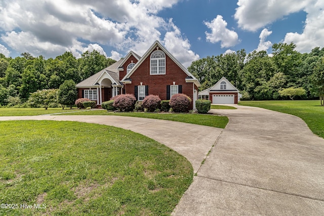 112 Highwoods Dr, Goldsboro, NC 27530 - traditional home featuring brick siding, a front lawn, curved driveway, an outdoor structure, and a detached garage