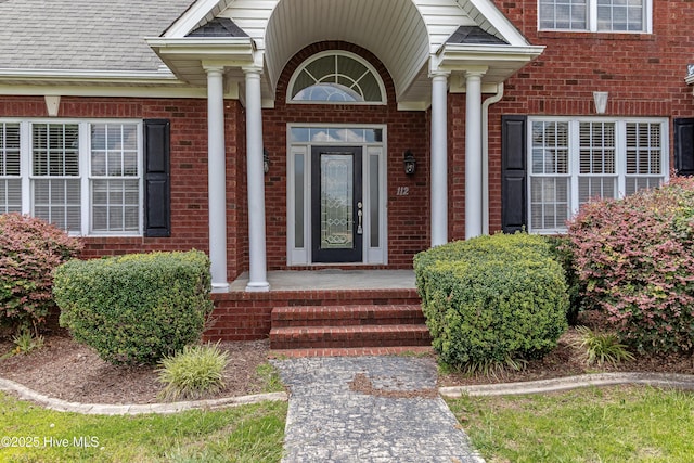 112 Highwoods Dr, Goldsboro, NC 27530 - doorway to property featuring brick siding and covered porch