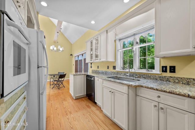 32 Windy Ct, Oriental, NC 28571 - kitchen with white appliances, a chandelier, lofted ceiling, light wood finished floors, and white cabinets