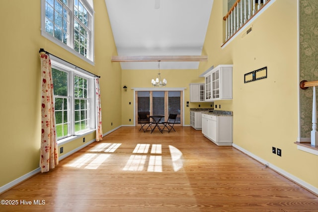 32 Windy Ct, Oriental, NC 28571 - living room featuring a towering ceiling, a chandelier, and light wood-style floors