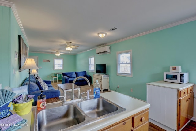 6703 13th Ave, North Topsail Beach, NC 28460 - kitchen featuring open floor plan, white microwave, crown molding, a wall mounted AC, and light countertops