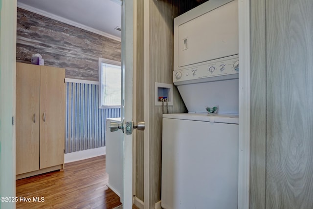 6703 13th Ave, North Topsail Beach, NC 28460 - washroom featuring stacked washer and clothes dryer and wood finished floors