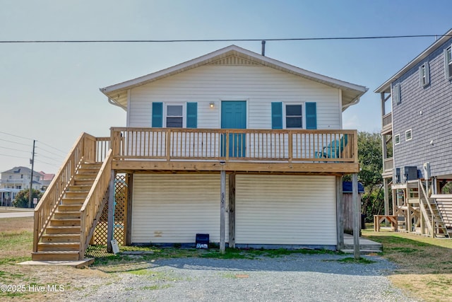 6703 13th Ave, North Topsail Beach, NC 28460 - view of front of property featuring stairs, a wooden deck, and a carport