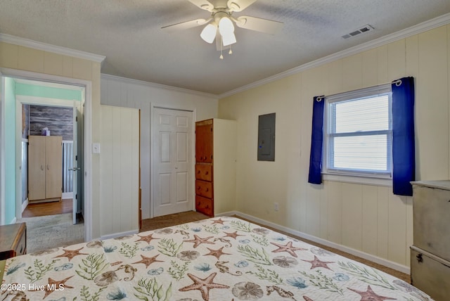 6703 13th Ave, North Topsail Beach, NC 28460 - bedroom featuring electric panel, ornamental molding, carpet floors, a textured ceiling, and a ceiling fan