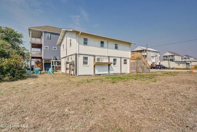6703 13th Ave, North Topsail Beach, NC 28460 - rear view of house with a yard, a residential view, and stairs