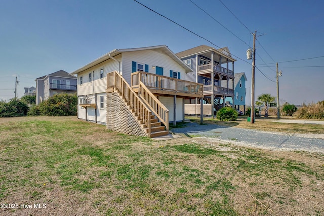 6703 13th Ave, North Topsail Beach, NC 28460 - back of house with stairs, a lawn, and a wooden deck