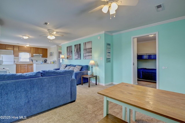 6703 13th Ave, North Topsail Beach, NC 28460 - living room featuring a ceiling fan, crown molding, and light colored carpet