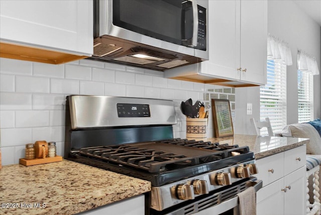 1673 White Starfish Ct, Calabash, NC 28467 - kitchen featuring appliances with stainless steel finishes, backsplash, white cabinetry, and light stone counters