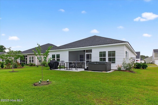 1673 White Starfish Ct, Calabash, NC 28467 - rear view of house featuring a hot tub, a patio area, a lawn, ceiling fan, and a shingled roof