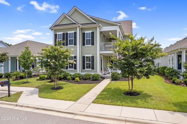 9154 Village Lake Dr SW, Calabash, NC 28467 - view of front of house featuring a balcony, a front yard, and covered porch