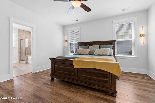 9154 Village Lake Dr SW, Calabash, NC 28467 - bedroom with dark wood-style flooring, connected bathroom, and a ceiling fan
