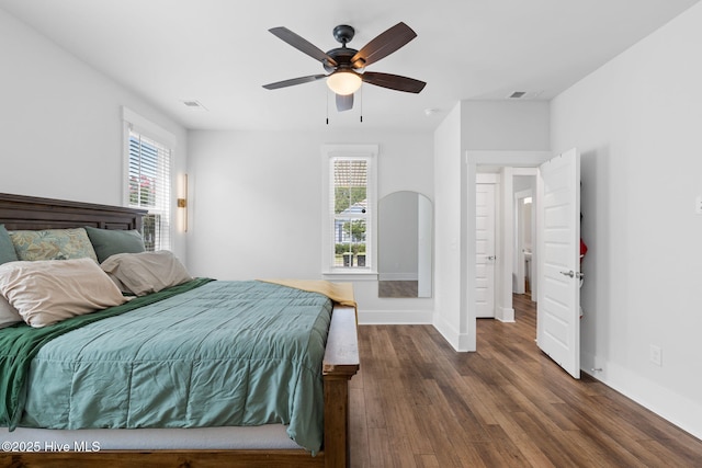 9154 Village Lake Dr SW, Calabash, NC 28467 - bedroom with multiple windows, dark wood finished floors, and a ceiling fan