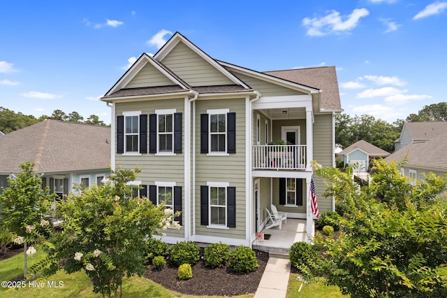 9154 Village Lake Dr SW, Calabash, NC 28467 - view of front of house with a balcony and a shingled roof
