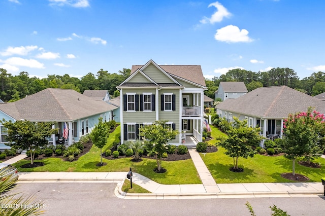 9154 Village Lake Dr SW, Calabash, NC 28467 - view of front of property with a balcony and a front lawn
