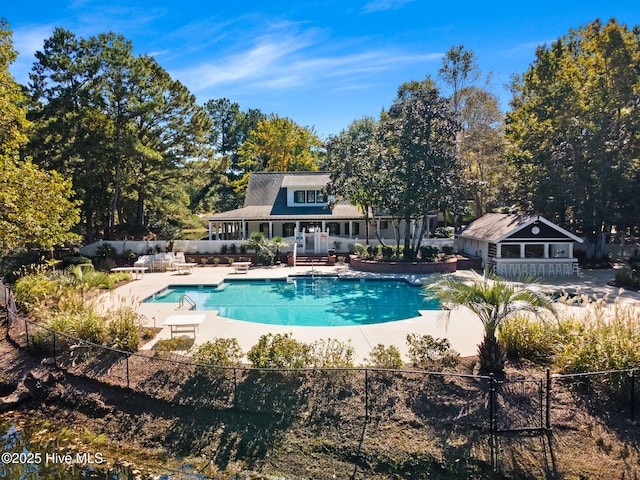 9154 Village Lake Dr SW, Calabash, NC 28467 - view of pool featuring a patio area, an outbuilding, and a storage structure