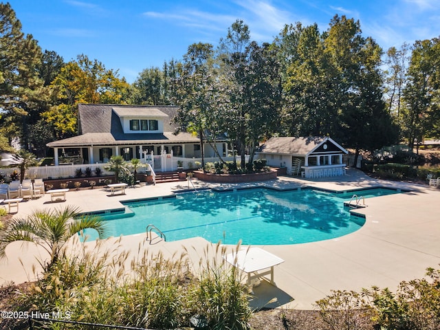 9154 Village Lake Dr SW, Calabash, NC 28467 - community pool with a patio, a storage structure, and an outbuilding