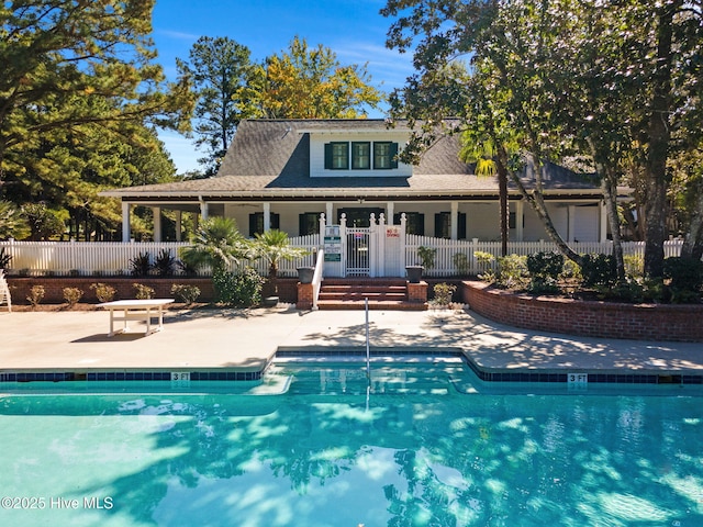 9154 Village Lake Dr SW, Calabash, NC 28467 - back of house with a patio and a community pool