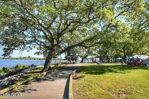 9154 Village Lake Dr SW, Calabash, NC 28467 - view of home's community featuring a yard and a water view