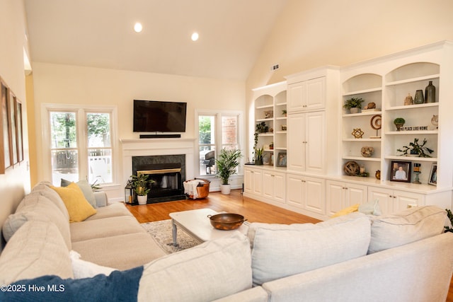 4725 Wedgefield Dr, Wilmington, NC 28409 - living room featuring high vaulted ceiling, light wood-style flooring, a fireplace, and recessed lighting