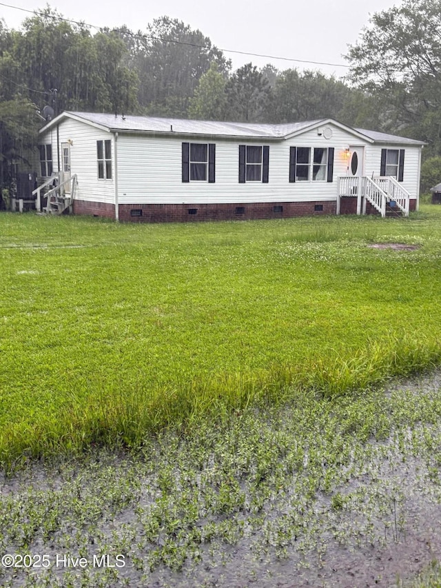 626 Poyners Rd, Moyock, NC 27958 - manufactured / mobile home with crawl space and a front lawn