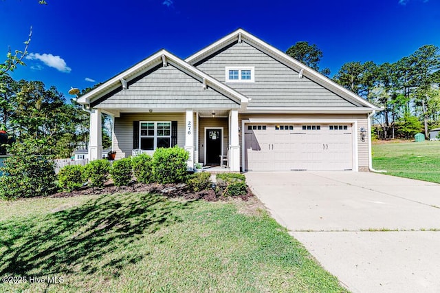276 Widgeon Way, Lillington, NC 27546 - view of front of home featuring a garage, concrete driveway, a front lawn, and covered porch