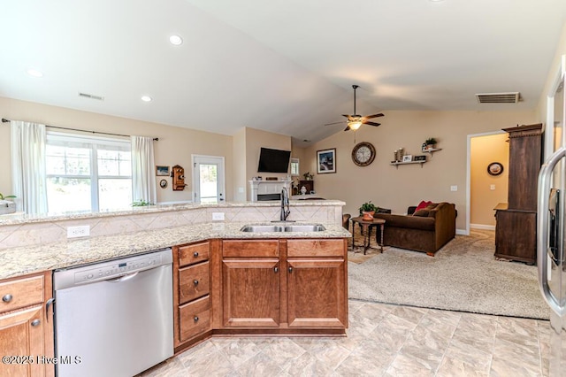 276 Widgeon Way, Lillington, NC 27546 - kitchen featuring dishwasher, vaulted ceiling, open floor plan, a ceiling fan, and brown cabinets
