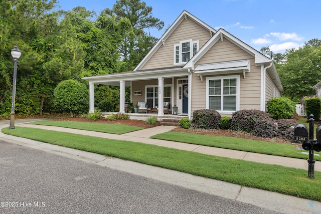 8203 Brays Dr, Wilmington, NC 28411 - view of front of house featuring covered porch and a front lawn