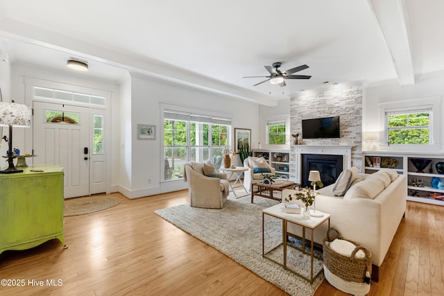 8203 Brays Dr, Wilmington, NC 28411 - living room with ceiling fan, a fireplace, light wood-style flooring, and beam ceiling