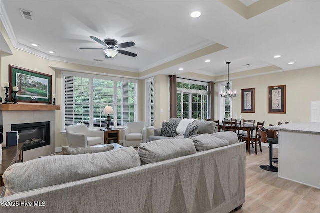 240 Cochrane Castle Cir Unit F, Pinehurst, NC 28374 - living area featuring ornamental molding, ceiling fan, a glass covered fireplace, light wood-type flooring, and a chandelier