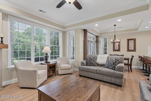 240 Cochrane Castle Cir Unit F, Pinehurst, NC 28374 - living room featuring a chandelier, ornamental molding, a raised ceiling, light wood-type flooring, and ceiling fan