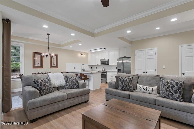 240 Cochrane Castle Cir Unit F, Pinehurst, NC 28374 - living area with a raised ceiling, ornamental molding, light wood finished floors, a chandelier, and recessed lighting