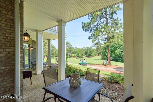 240 Cochrane Castle Cir Unit F, Pinehurst, NC 28374 - view of patio with outdoor dining space and view of scattered trees